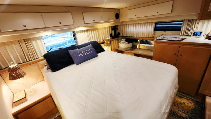 Now Or Never Yacht Photos Pics 1995 Carver 440 Aft Cabin Motor Yacht bedroom with cozy decor and "Ahoy" pillow.