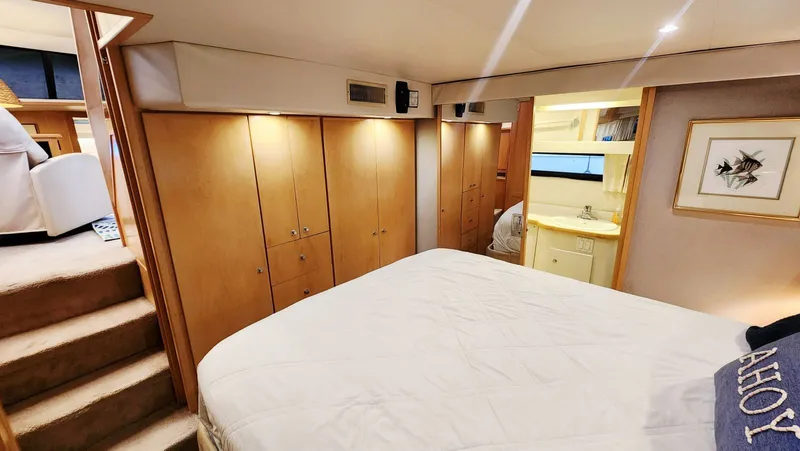 Now Or Never Yacht Photos Pics Luxurious 1995 Carver 440 Aft Cabin Motor Yacht bedroom with cozy decor and ample storage.