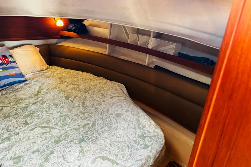 Walrus Yacht Photos Pics Cozy cabin interior of 2012 Ranger Tugs R-31 with patterned bedding and warm lighting.