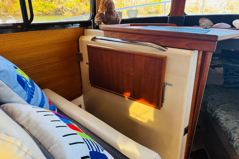 Walrus Yacht Photos Pics Interior of 2012 Ranger Tugs R-31 with wooden accents and colorful cushions.