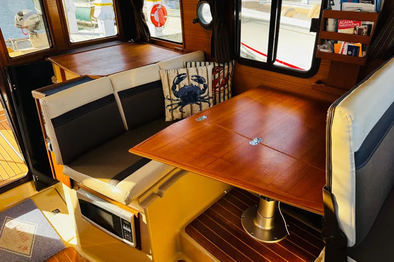 Walrus Yacht Photos Pics Interior of 2012 Ranger Tugs R-31 with dining area and nautical decor.