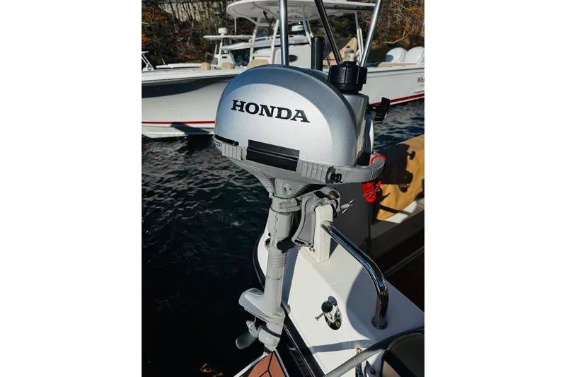 Walrus Yacht Photos Pics Honda outboard motor on 2012 Ranger Tugs R-31 boat, docked on water.