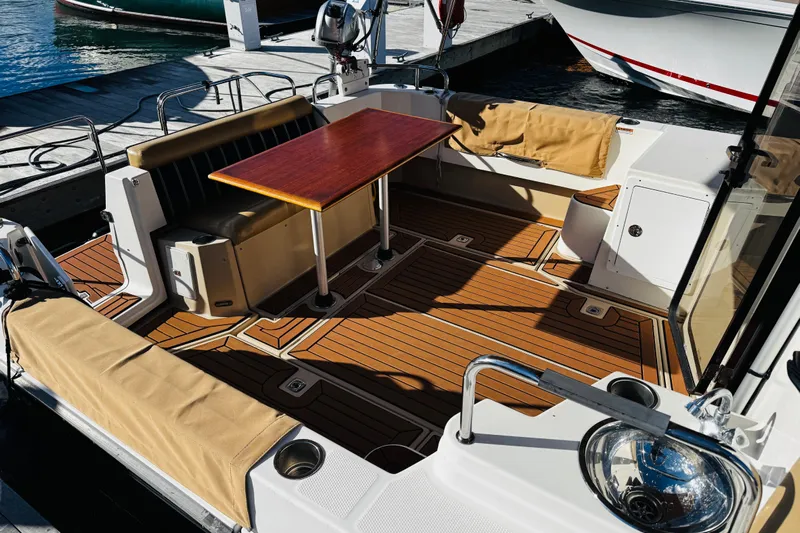 Walrus Yacht Photos Pics 2012 Ranger Tugs R-31 boat interior with wooden deck and seating area.