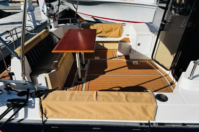 Walrus Yacht Photos Pics 2012 Ranger Tugs R-31 boat deck with seating and wooden table.