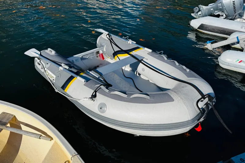 Walrus Yacht Photos Pics Inflatable dinghy docked on water, associated with 2012 Ranger Tugs R-31 model.