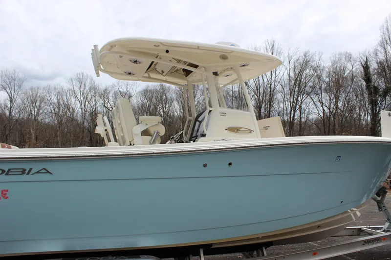  Yacht Photos Pics 2022 Cobia 280 Center Console boat in light blue, parked outdoors.