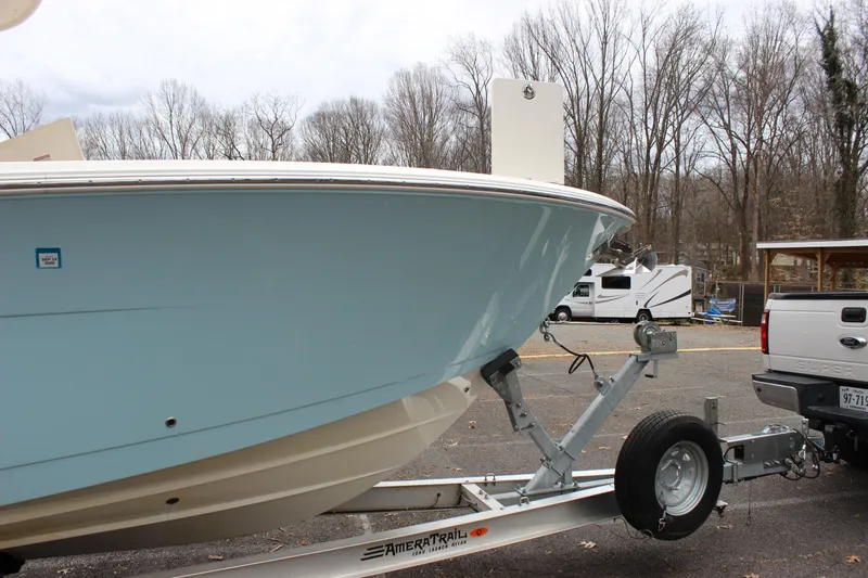  Yacht Photos Pics 2022 Cobia 280 Center Console boat on trailer in parking lot.