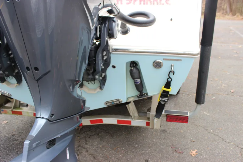  Yacht Photos Pics 2022 Cobia 280 Center Console boat on trailer, showing outboard motor and rear details.