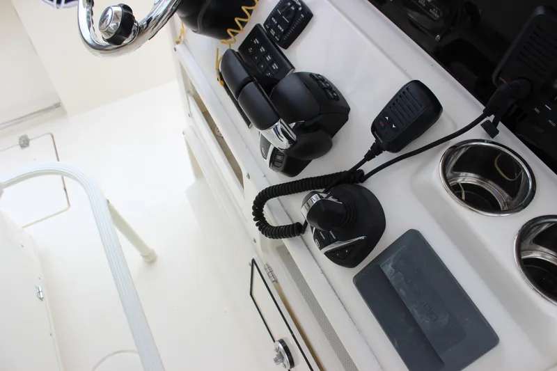  Yacht Photos Pics 2022 Cobia 280 Center Console helm with controls and steering wheel.