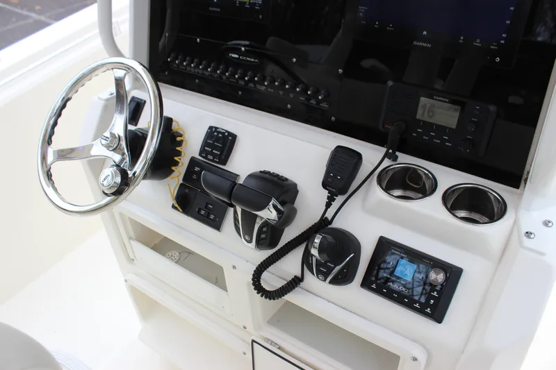  Yacht Photos Pics 2022 Cobia 280 Center Console dashboard with steering wheel and navigation controls.