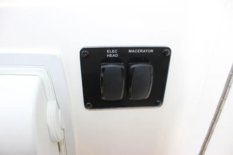 Yacht Photos Pics Control panel with switches for electric head and macerator on 2022 Cobia 280 Center Console.