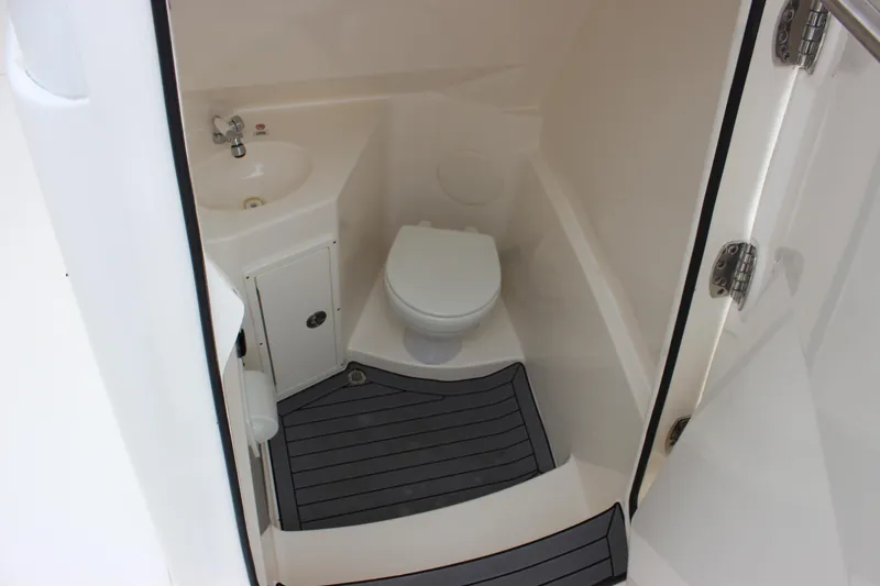  Yacht Photos Pics 2022 Cobia 280 Center Console boat bathroom with sink and toilet.
