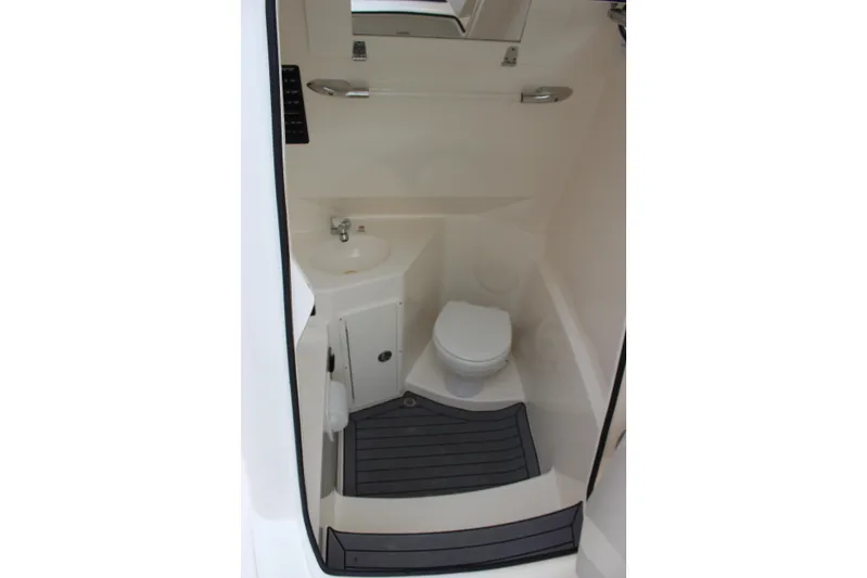  Yacht Photos Pics 2022 Cobia 280 Center Console boat interior bathroom with toilet and sink.