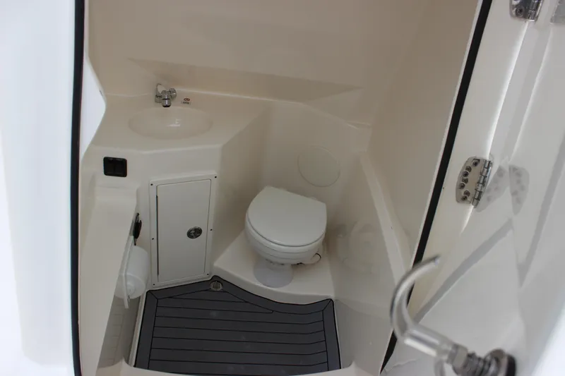  Yacht Photos Pics 2022 Cobia 280 Center Console boat interior bathroom with sink and toilet.