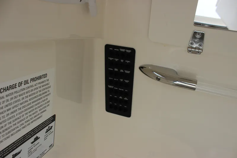  Yacht Photos Pics 2022 Cobia 280 Center Console interior with control panel and safety notice.