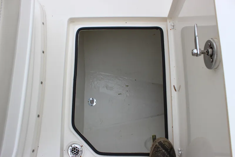  Yacht Photos Pics Storage compartment of 2022 Cobia 280 Center Console boat, open with visible latch.