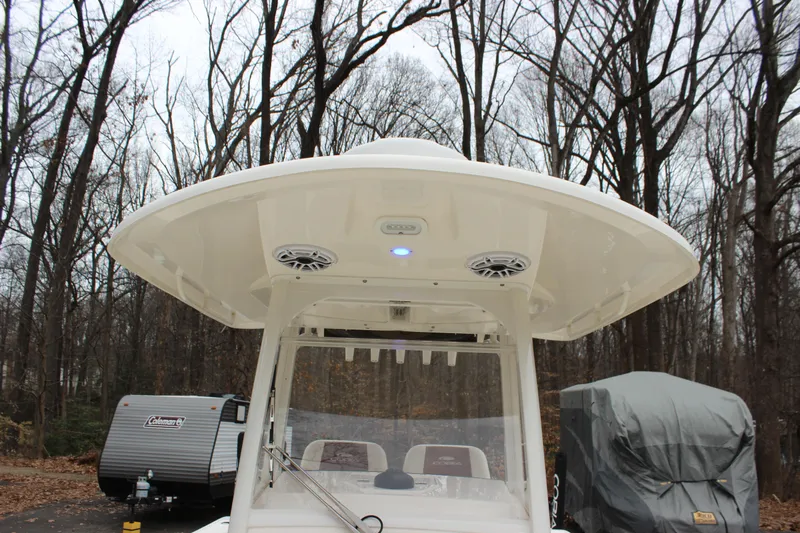  Yacht Photos Pics 2022 Cobia 280 Center Console boat with T-top in wooded area.