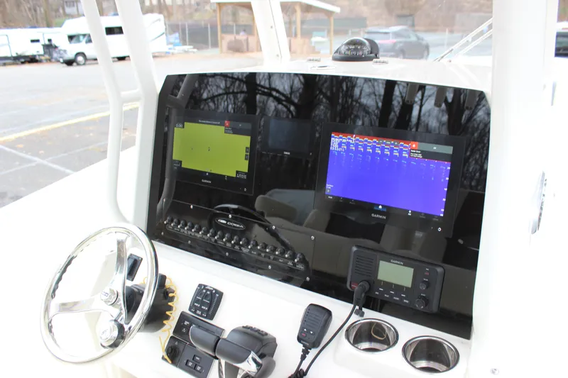  Yacht Photos Pics 2022 Cobia 280 Center Console dashboard with Garmin displays and steering wheel.