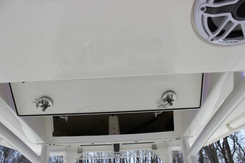  Yacht Photos Pics 2022 Cobia 280 Center Console boat with open storage compartment and speaker.
