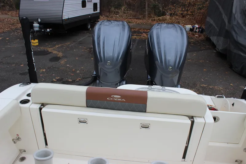  Yacht Photos Pics 2022 Cobia 280 Center Console boat with dual engines, parked near a trailer.