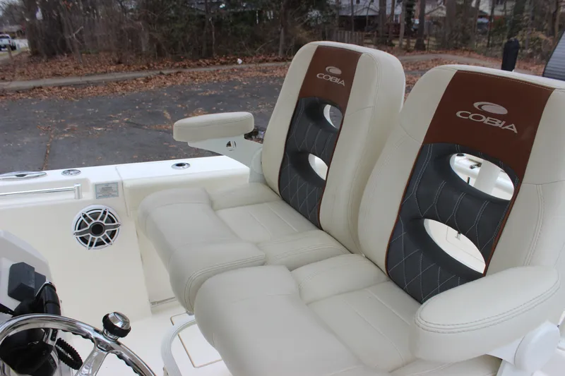 Yacht Photos Pics 2022 Cobia 280 Center Console boat seats with armrests and speaker detail.