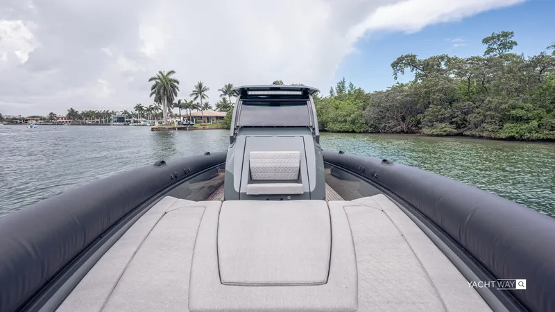 New 2025 Skipper 38 Twin Mercury 400 - Sunbed Ed Yacht Photos Pics 2025 Skipper-BSK 38NC luxury yacht on serene water with lush greenery.