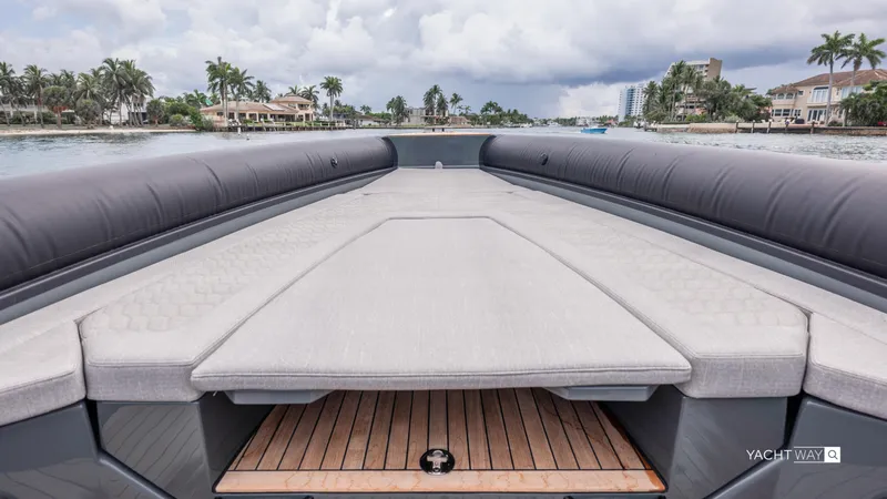 New 2025 Skipper 38 Twin Mercury 400 - Sunbed Ed Yacht Photos Pics Luxurious 2025 Skipper-BSK 38NC yacht deck with cushioned seating, overlooking waterfront homes.