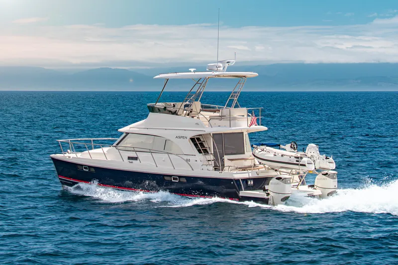  Yacht Photos Pics 2026 Aspen C128 Flybridge yacht cruising on open sea under clear sky.