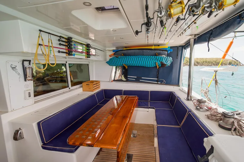  Yacht Photos Pics Spacious interior of 2007 Lagoon 500 yacht with seating, fishing rods, and ocean view.