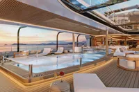 Luxurious yacht deck with pool, modern seating, and ocean view at sunset, Custom Project Raptor 2028.