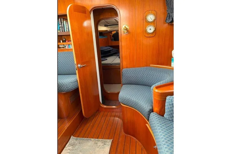  Yacht Photos Pics Interior of 1995 Beneteau Oceanis 44 CC sailboat with wooden finish and blue seating.