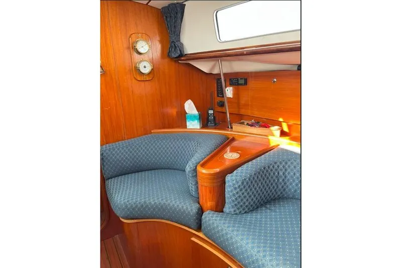  Yacht Photos Pics Interior of 1995 Beneteau Oceanis 44 CC yacht with blue cushioned seating.