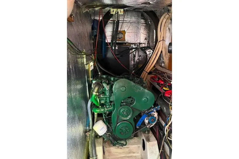  Yacht Photos Pics Engine compartment of a 1995 Beneteau Oceanis 44 CC sailboat, featuring a green engine.