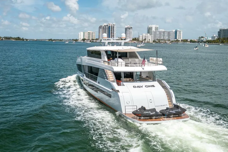 Day One Yacht Photos Pics Luxury Hargrave C92 yacht cruising in sunny waters, 2020 model, with city skyline in background.