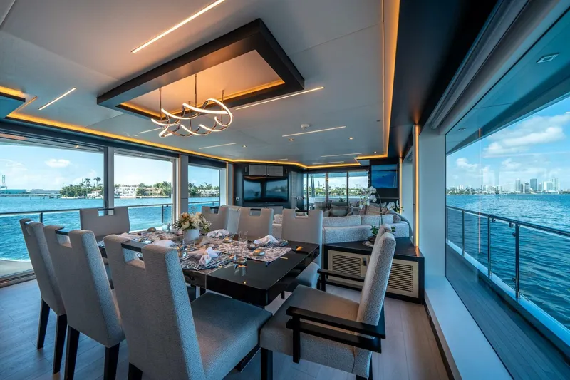 Day One Yacht Photos Pics Luxurious dining area on 2020 Hargrave C92 yacht with ocean views and elegant decor.