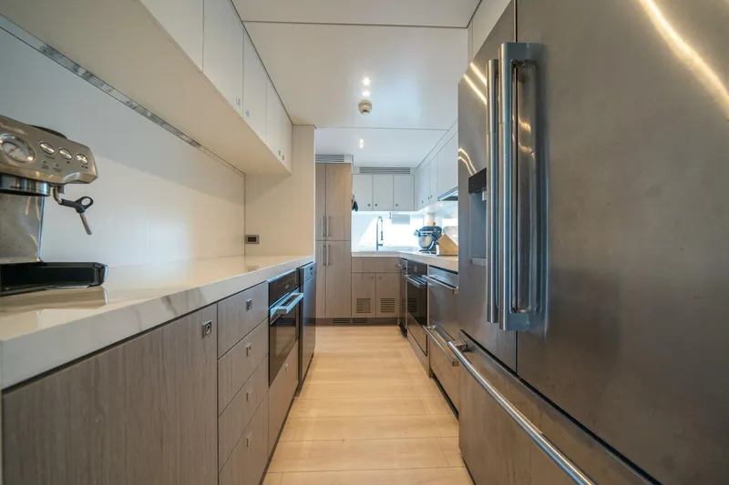 Day One Yacht Photos Pics Modern kitchen interior on 2020 Hargrave C92 yacht, featuring stainless steel appliances and sleek cabinetry.