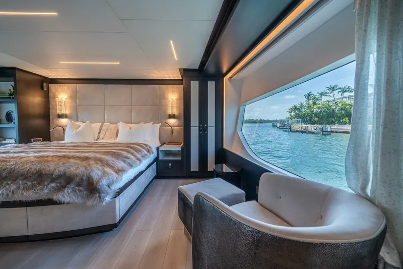 Day One Yacht Photos Pics Luxurious 2020 Hargrave C92 yacht bedroom with waterfront view, elegant decor, and plush bedding.