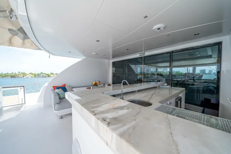 Day One Yacht Photos Pics Luxurious 2020 Hargrave C92 yacht deck with marble bar and waterfront view.