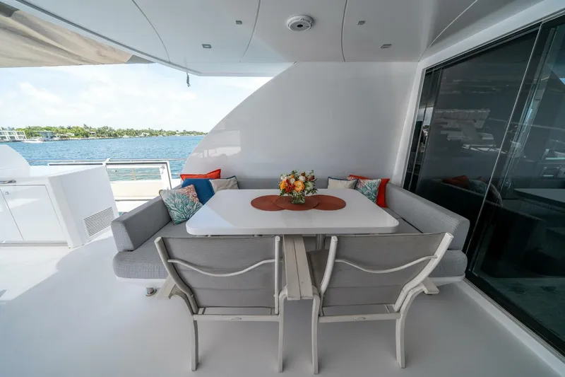 Day One Yacht Photos Pics Luxurious 2020 Hargrave C92 yacht deck with elegant dining area and ocean view.