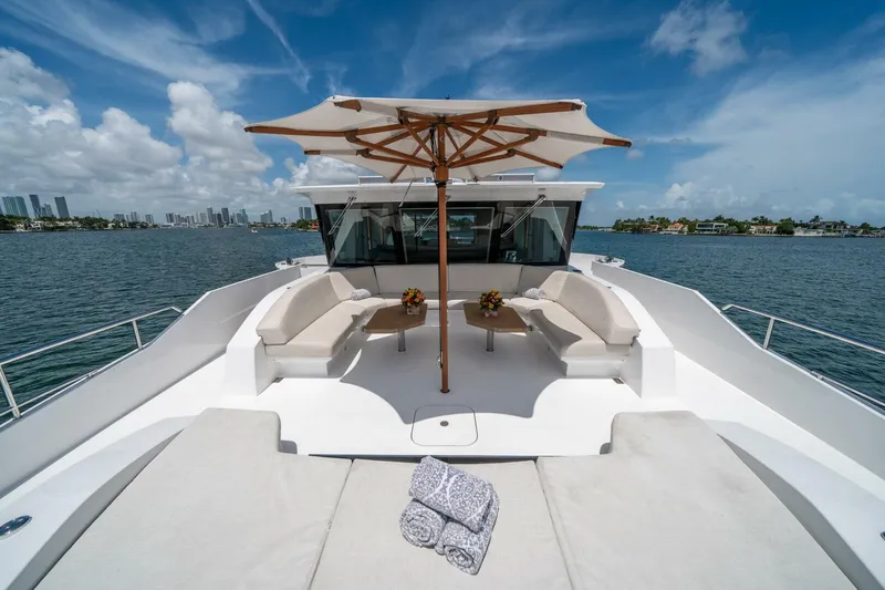 Day One Yacht Photos Pics Luxurious 2020 Hargrave C92 yacht deck with seating, umbrella, and ocean view.