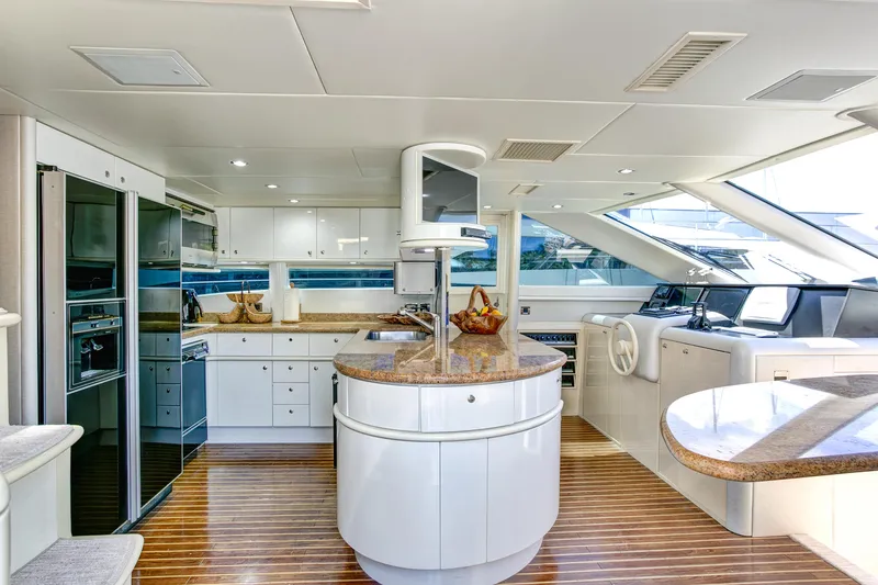 Mautica Yacht Photos Pics Luxurious 1994 Lazzara 76 yacht interior with modern kitchen and sleek design.