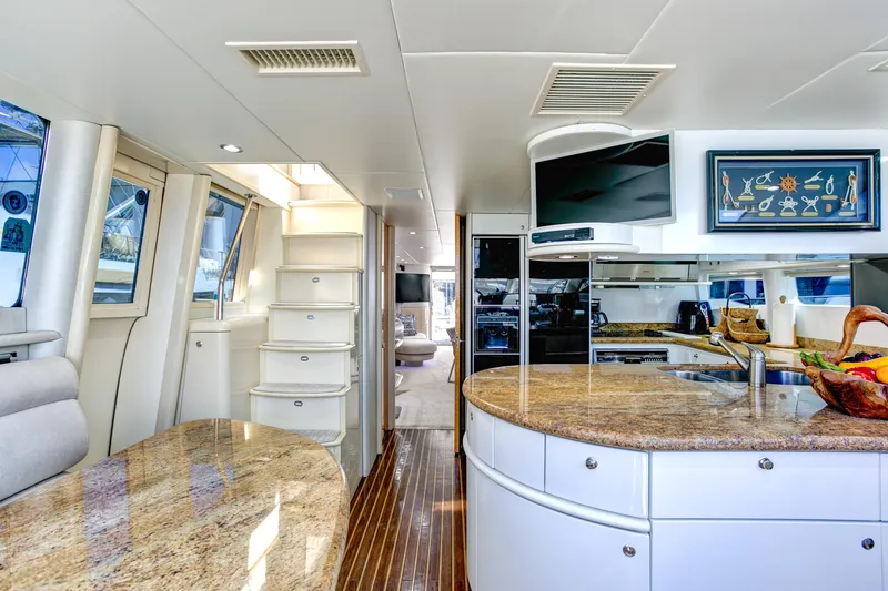 Mautica Yacht Photos Pics Luxurious interior of 1994 Lazzara 76 yacht with modern kitchen and elegant decor.