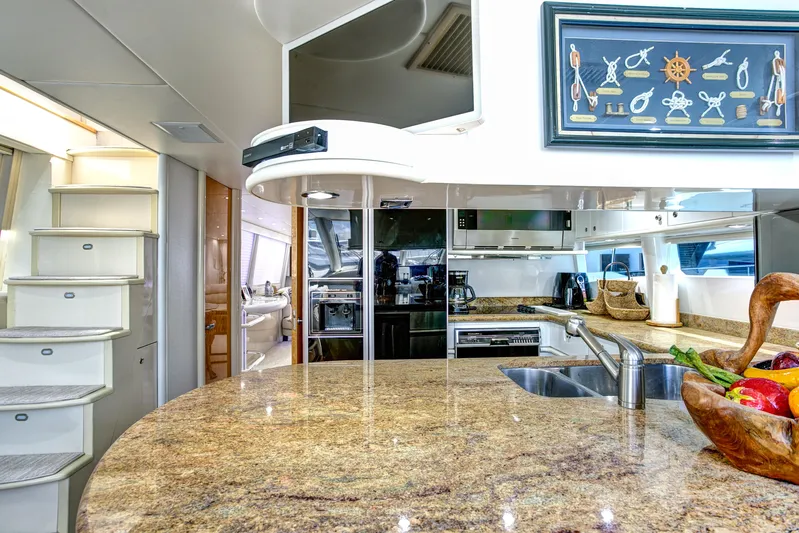 Mautica Yacht Photos Pics Luxurious 1994 Lazzara 76 yacht kitchen with granite countertops and modern appliances.
