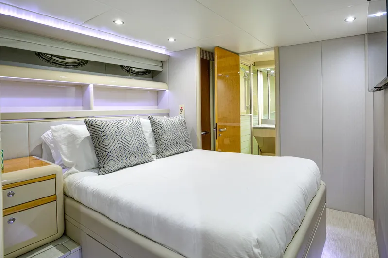 Mautica Yacht Photos Pics Luxurious bedroom interior on 1994 Lazzara 76 yacht with modern design and cozy bedding.