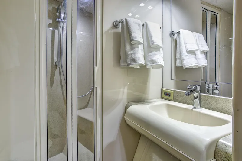 Mautica Yacht Photos Pics Luxurious bathroom in 1994 Lazzara 76 yacht with shower and elegant sink.