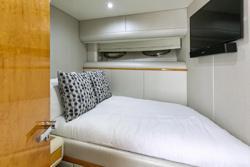 Mautica Yacht Photos Pics Luxurious bedroom interior of 1994 Lazzara 76 yacht with modern decor and TV.
