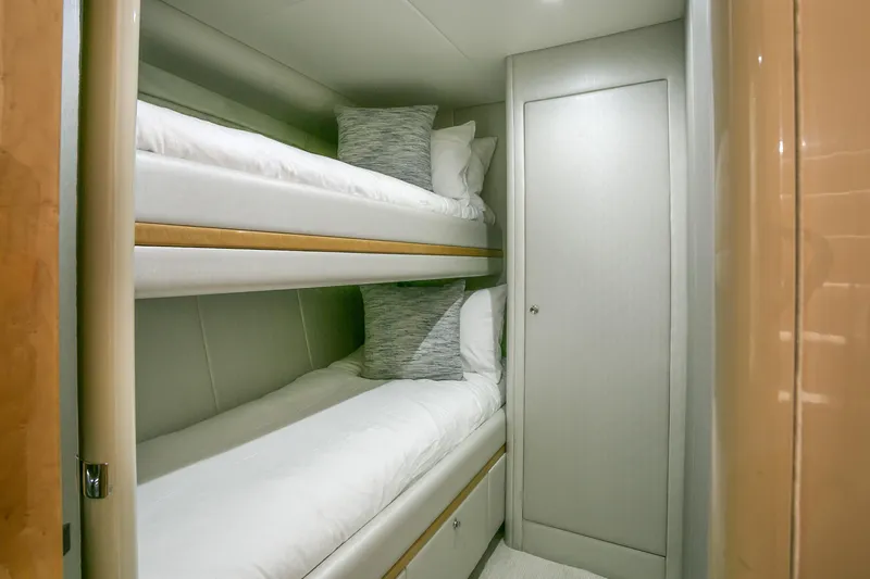 Mautica Yacht Photos Pics Bunk beds in a 1994 Lazzara 76 yacht cabin, featuring modern design and cozy bedding.