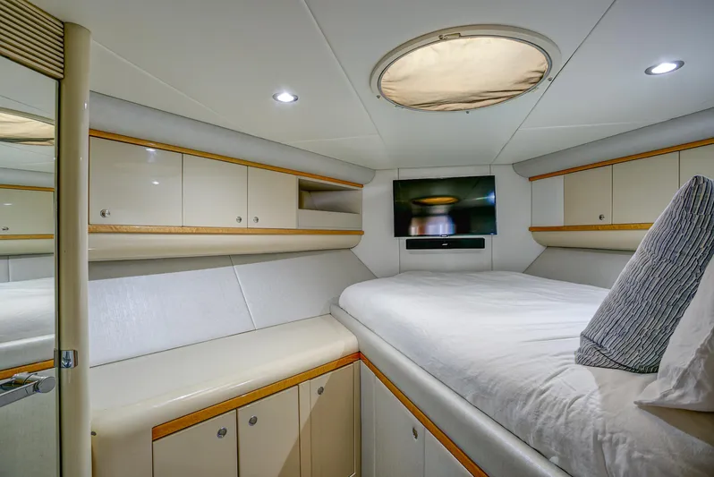 Mautica Yacht Photos Pics Luxurious 1994 Lazzara 76 yacht bedroom with modern decor and built-in storage.