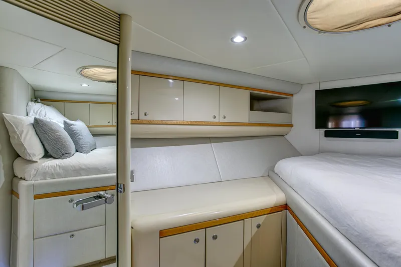 Mautica Yacht Photos Pics Luxurious 1994 Lazzara 76 yacht bedroom with modern decor and ample storage.