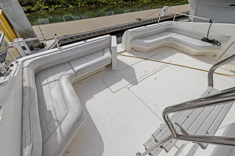  Yacht Photos Pics 1994 Sea Ray 550 Sedan Bridge boat deck with white seating and railing.